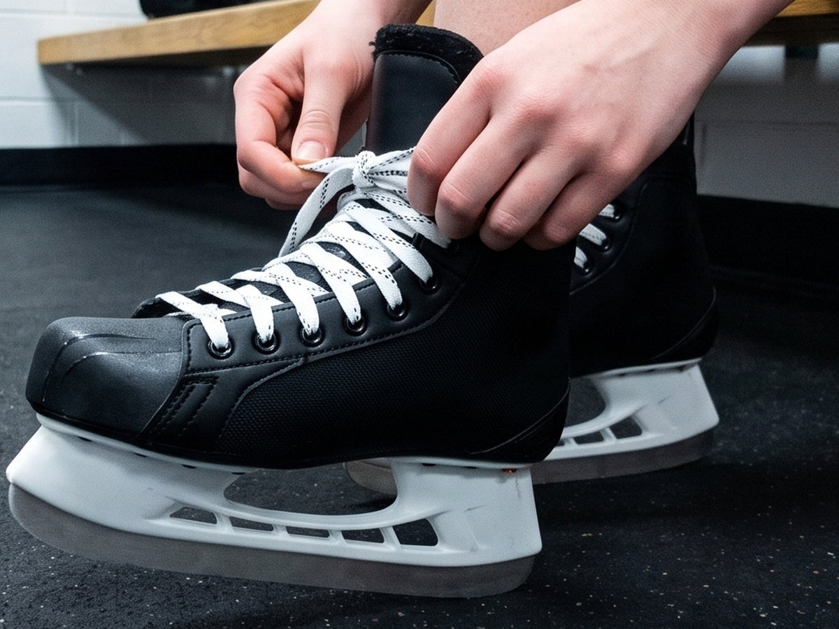 Lacing up a hockey skate before going on the ice