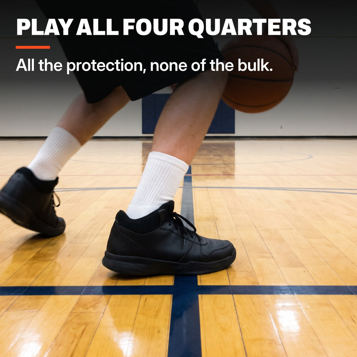 Basketball player planting and pivoting on a hardwood court