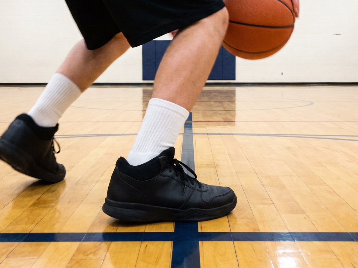 Basketball player making a hard stop on a hardwood court, close on the front of the shoe